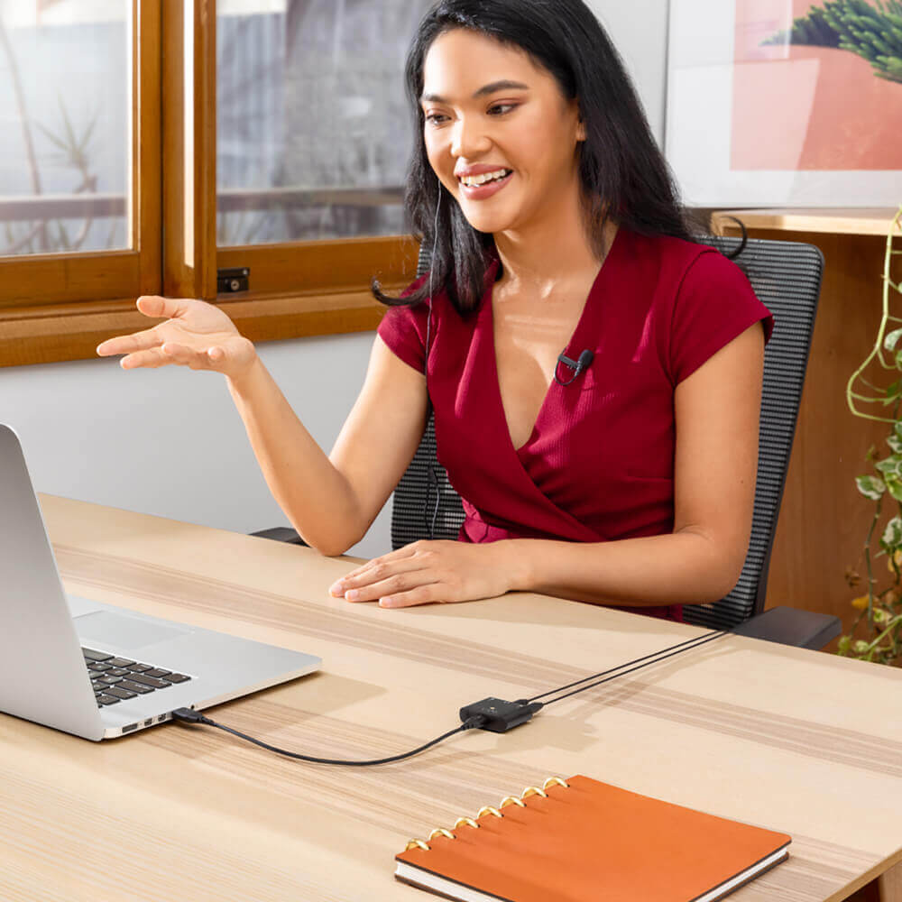 Girl by the window on laptop with lavalier and AI-Micro connected