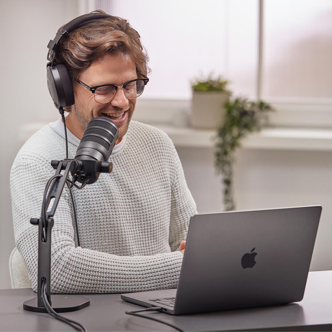 Man wearing NTH-100 speaking into PodMic USB on DS2 connected to MacBook