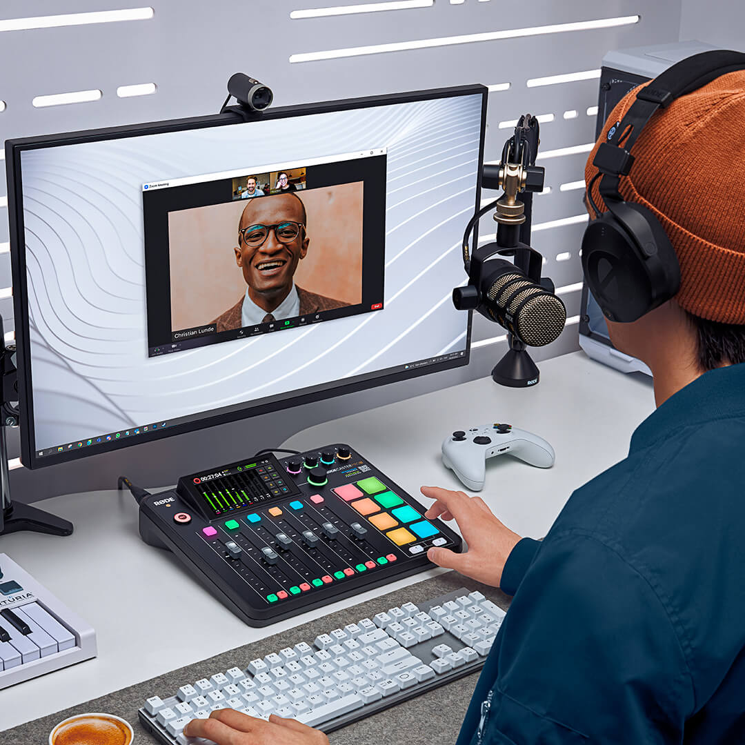 Person on video call with hand over RØDECaster Pro II