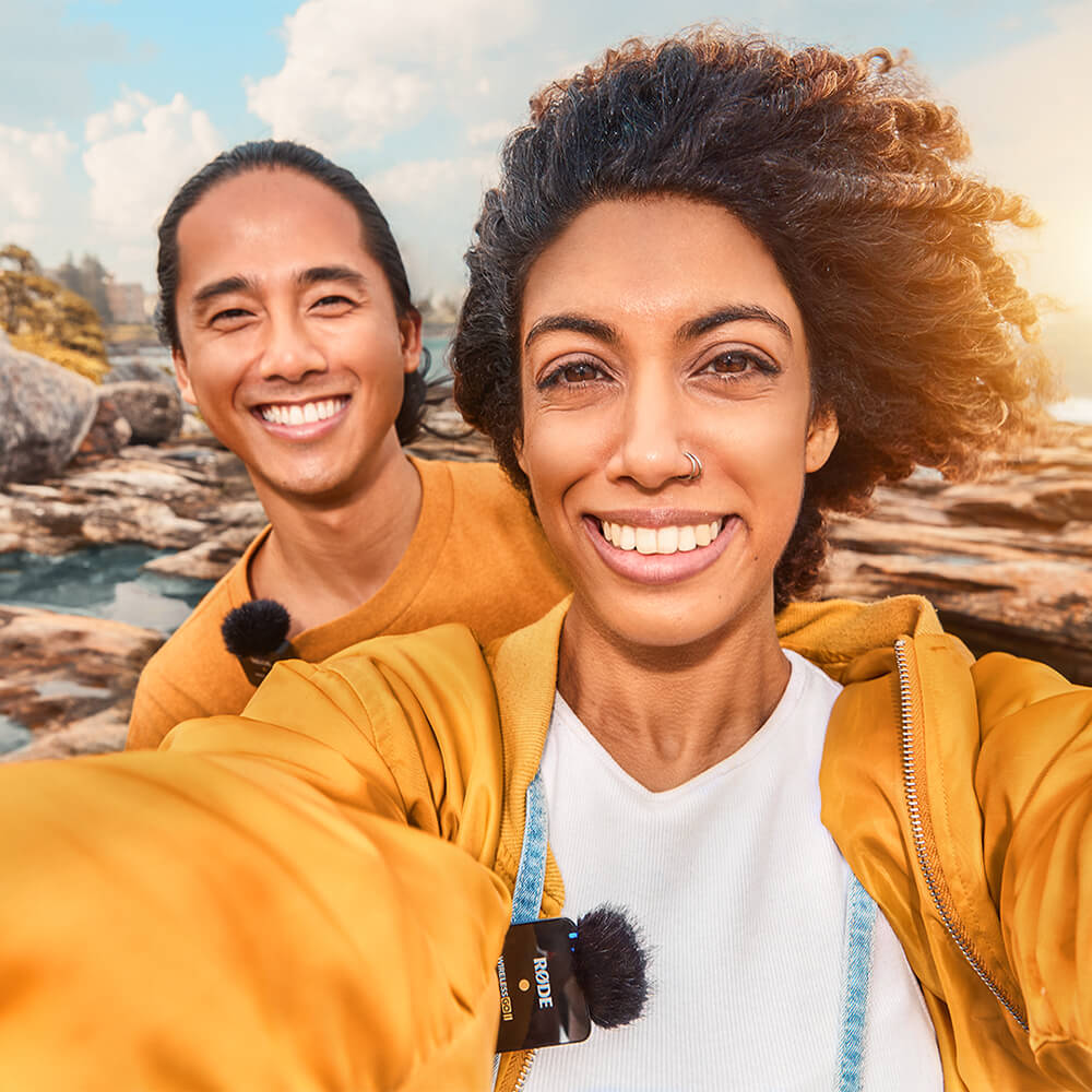 Couple vlogging in selfie mode outdoors by the water